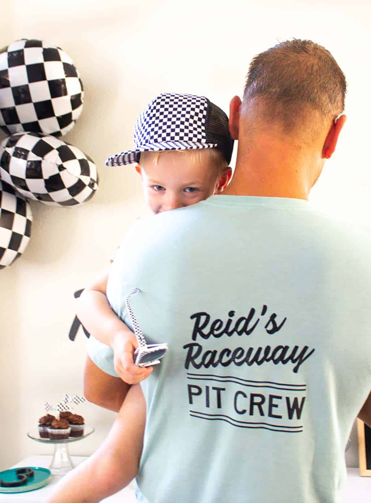 Dad wearing a handmade "Pit Crew" shirt at his son's race car birthday