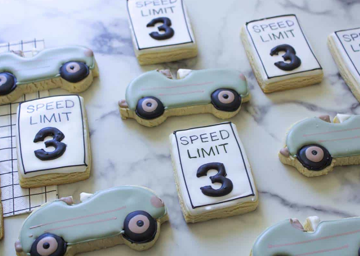 Vintage race car and speed limit sugar cookies decorated with the number 3